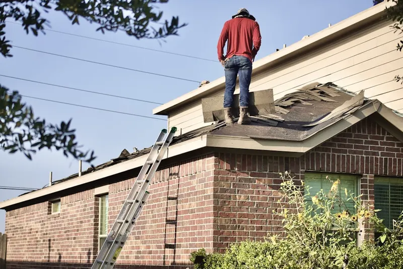Professional roofer working on a residential roof in Sophia